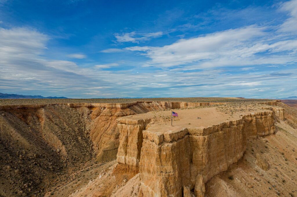 Flat-top mesa with an American flag above the canyons near Mesquite, Nevada