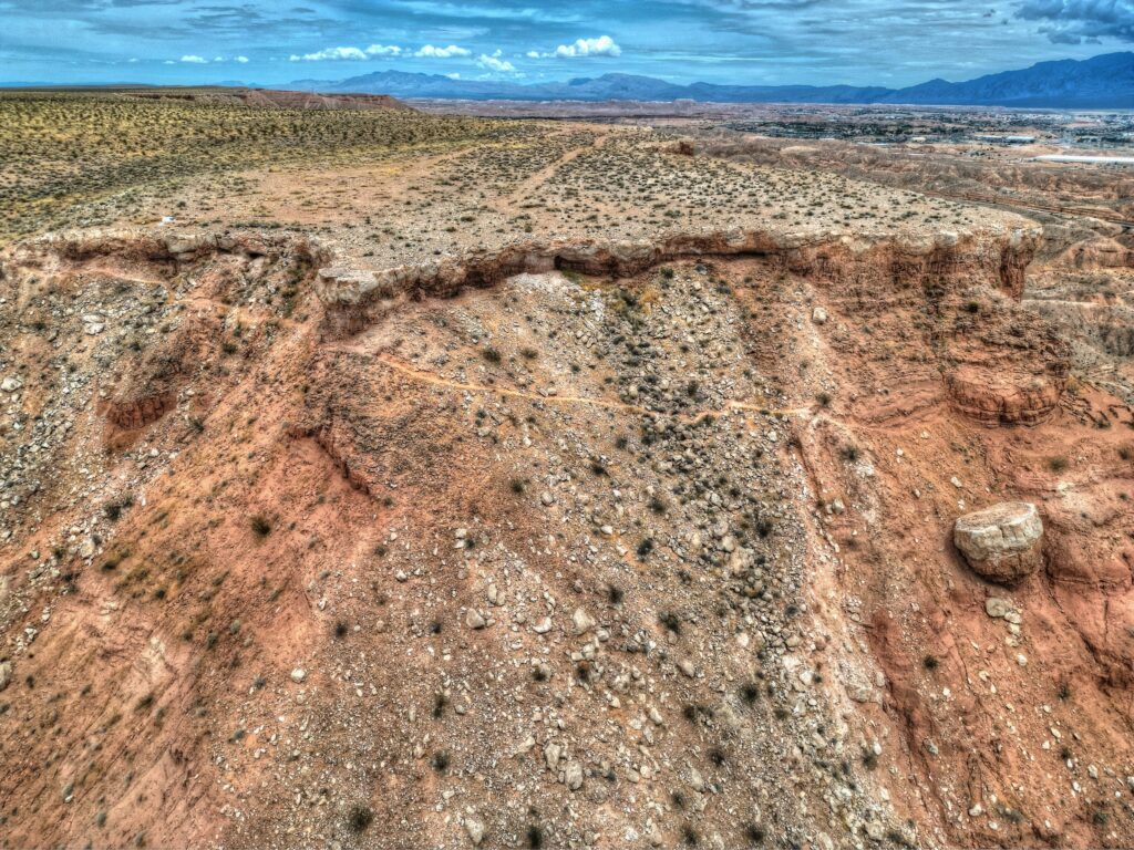 Aerial view of the mesa rim and the desert valley below